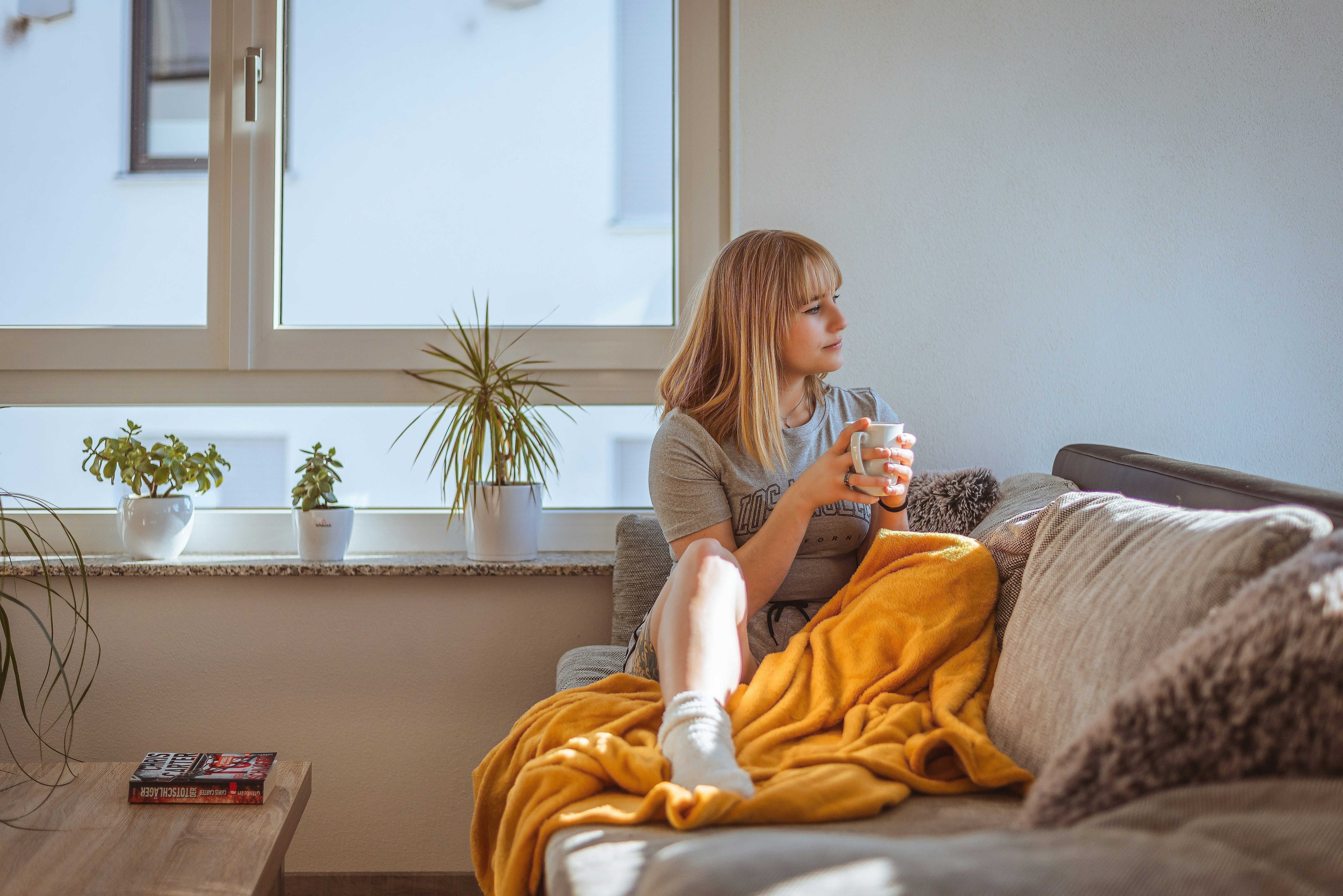 woman on a couch drinking tea