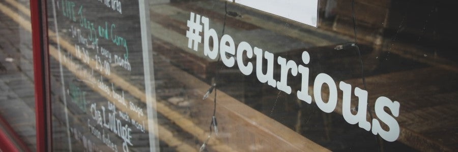 #becurious on the glass door