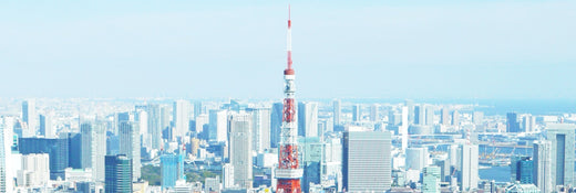 a skyline view of Tokyo with a phallic shaped tower front and center